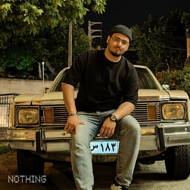 Arshia on vintage car at night